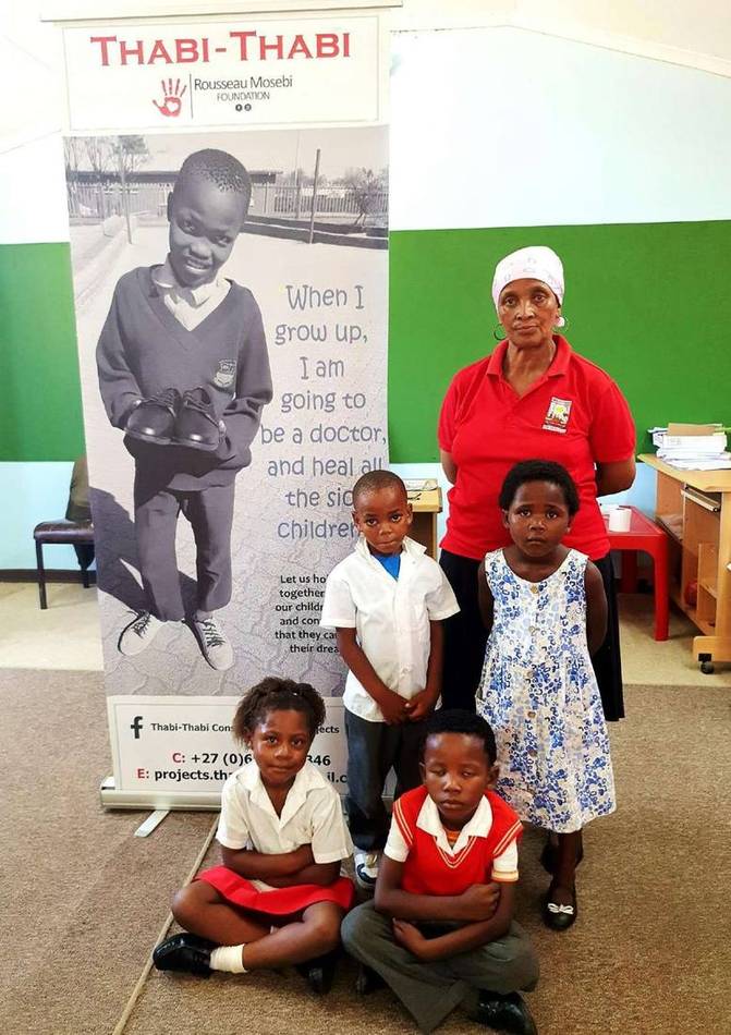Young children and their teacher at an Early Childhood Development centre