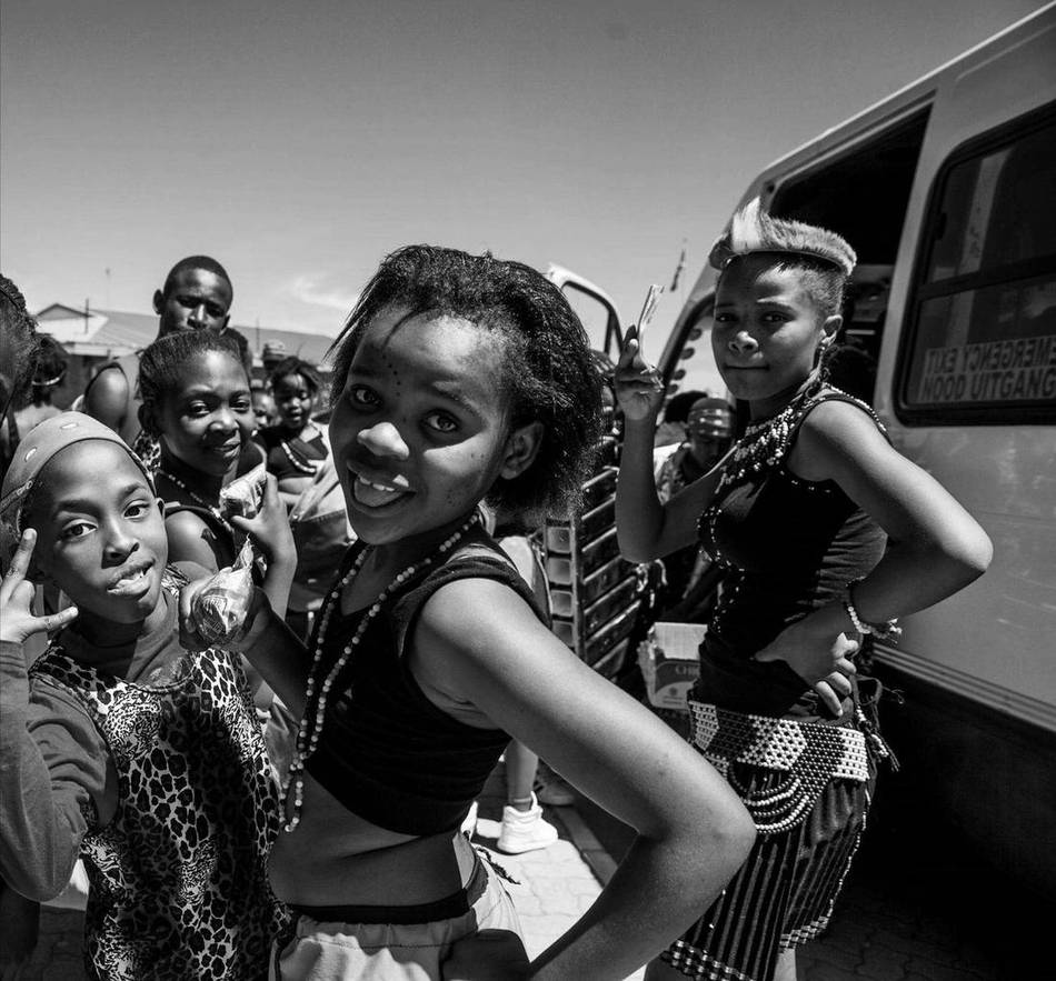 Young women in cultural dress at a community outreach event